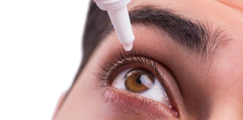 Close-up of a person using eye drops