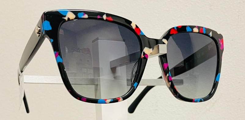A pair of black Kate Spade sunglasses with colorful accents on the frame.